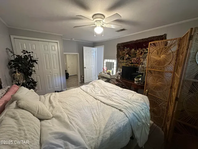 a bedroom with a bed and a chandelier