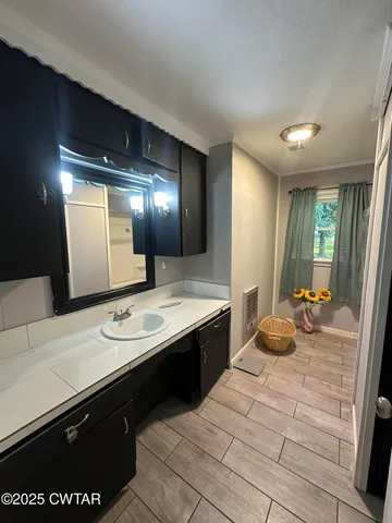 a spacious bathroom with a sink double vanity and a mirror