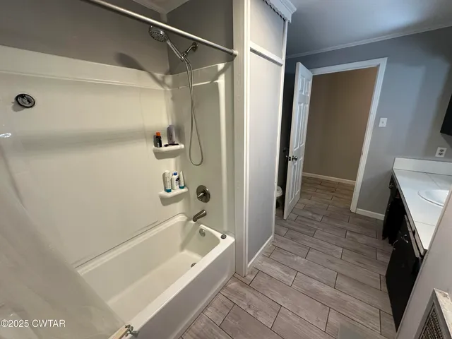a bathroom with a bathtub and a shower