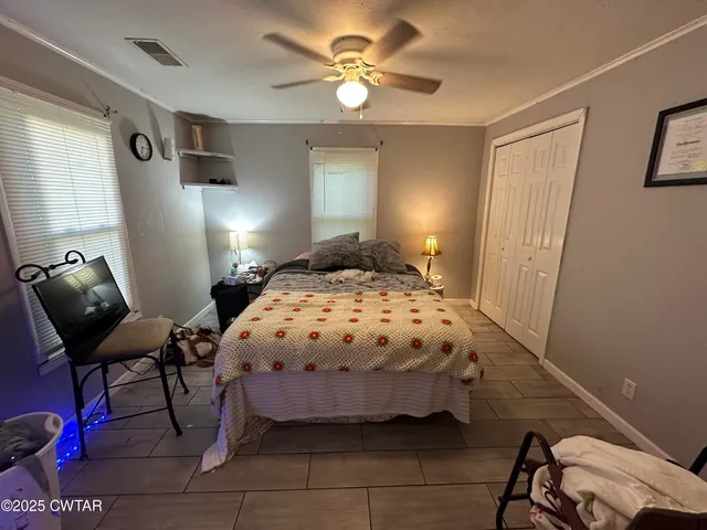 a bedroom with a bed and chair
