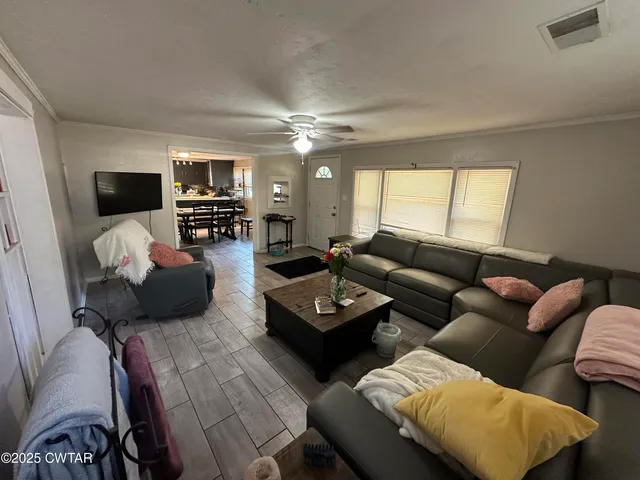 a living room with furniture and a flat screen tv