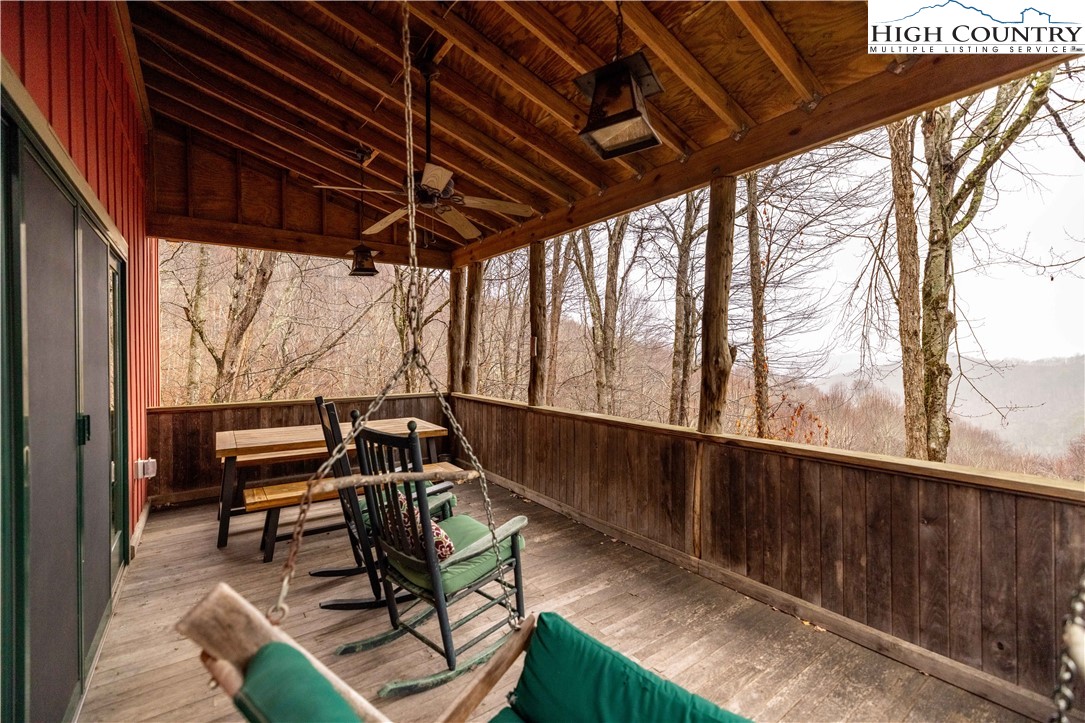 2822 Little Windfall Road Lansing, NC 28643 - Photo 20 of 40 a view of a chairs and table in patio with wooden fence