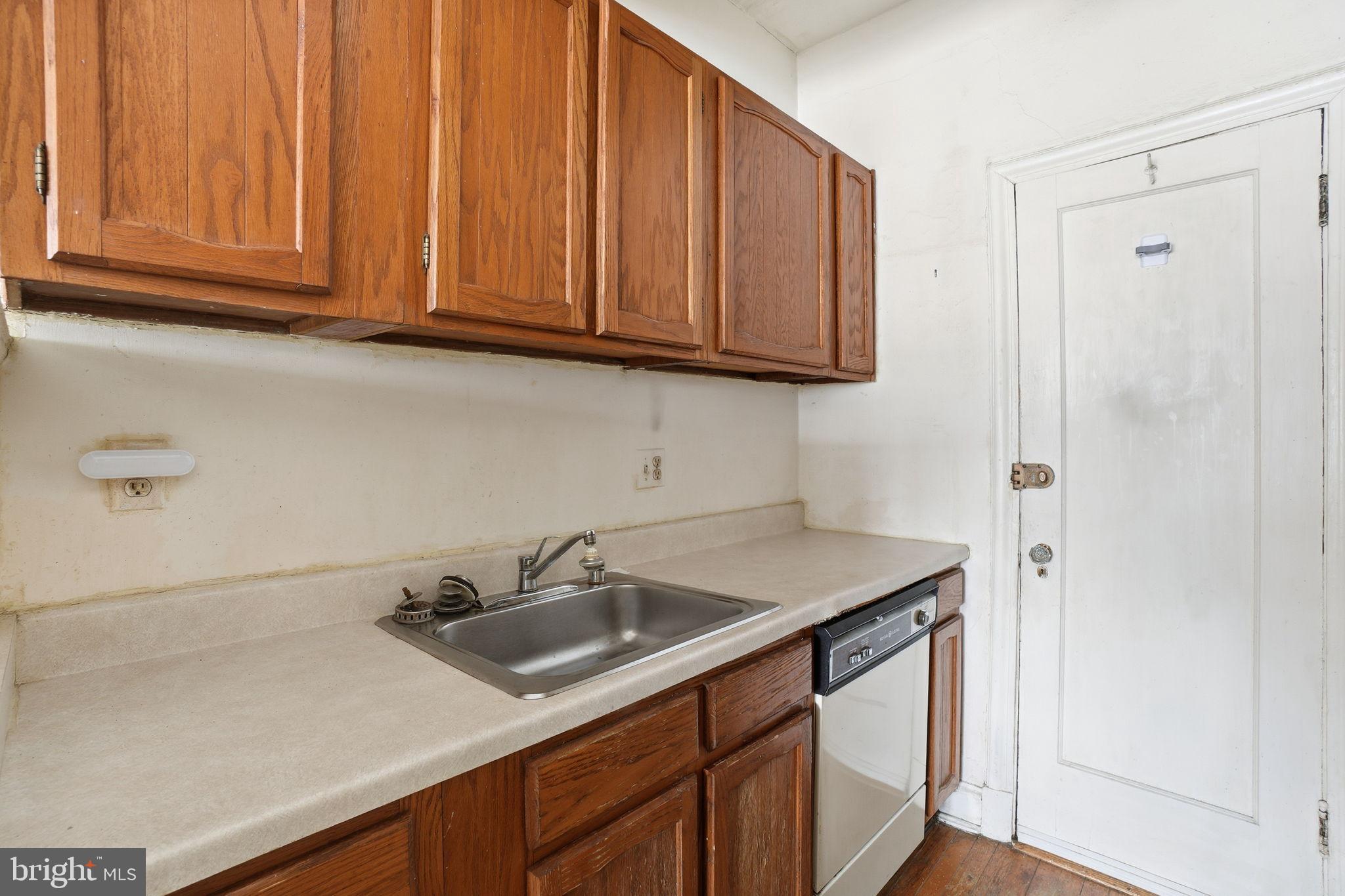 2040 Belmont Road Northwest, Unit 536 Washington, DC 20009 - Photo 15 of 25 Cozy kitchen with classic wooden cabinetry.