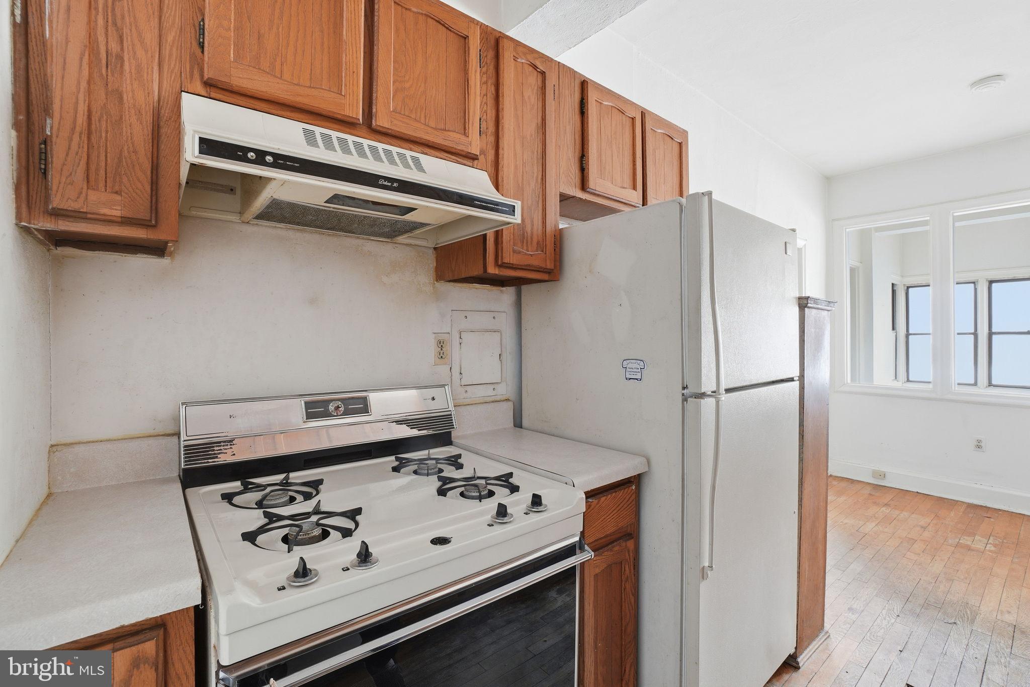 2040 Belmont Road Northwest, Unit 536 Washington, DC 20009 - Photo 16 of 25 Cozy kitchen with classic wooden cabinetry.
