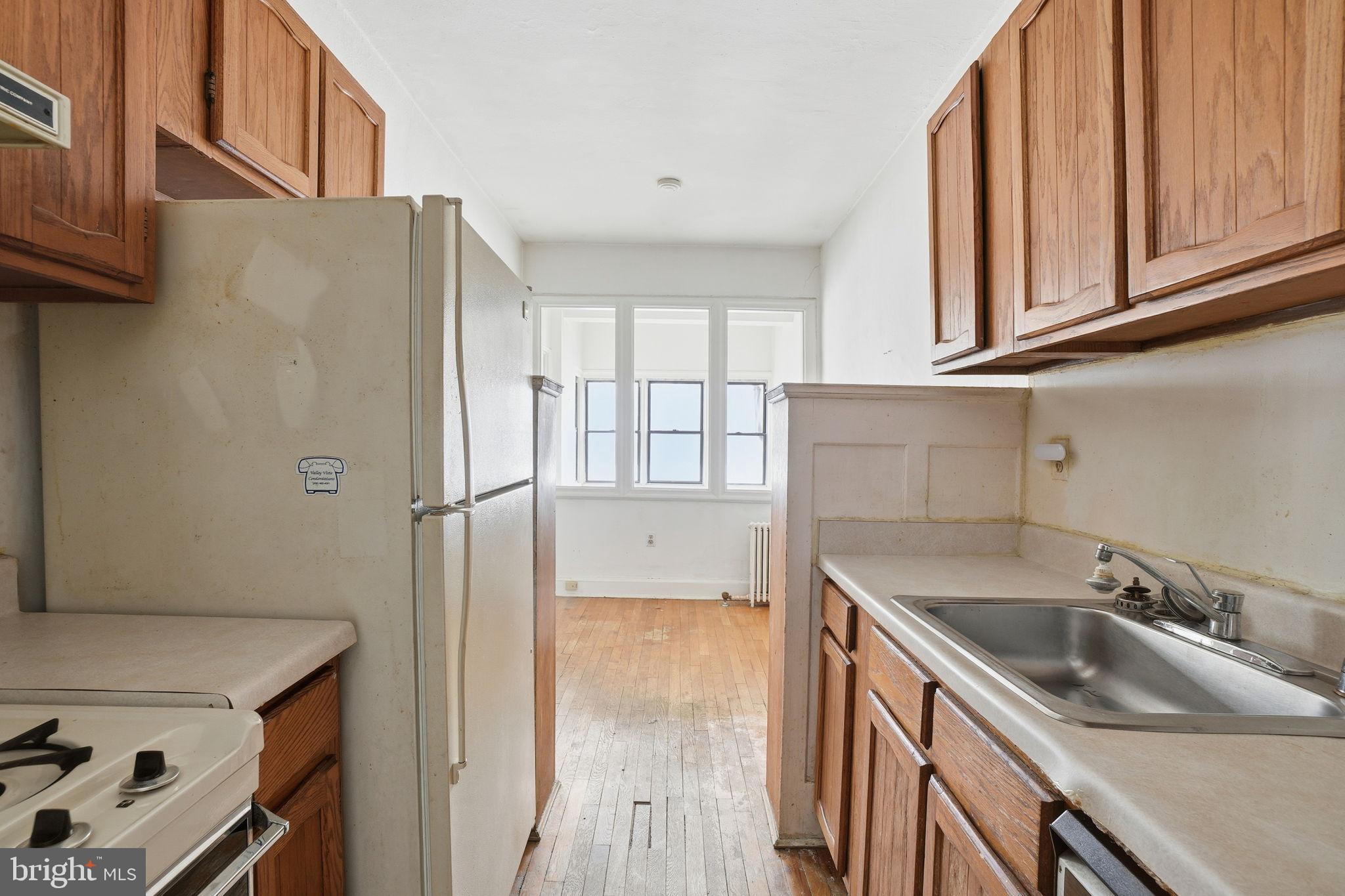 2040 Belmont Road Northwest, Unit 536 Washington, DC 20009 - Photo 19 of 31 a kitchen with stainless steel appliances granite countertop a sink stove and refrigerator