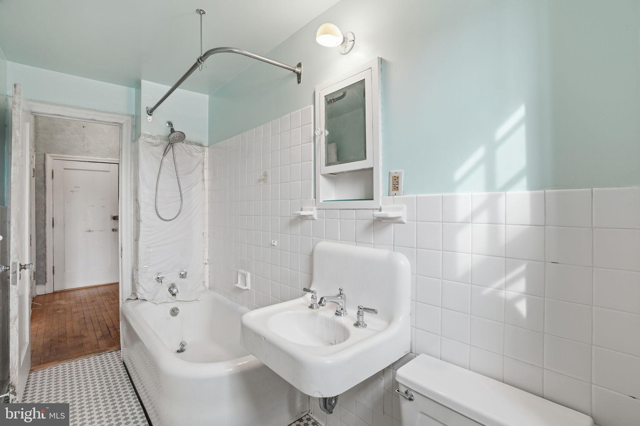 2040 Belmont Road Northwest, Unit 536 Washington, DC 20009 - Photo 23 of 31 a bathroom with a sink a toilet and shower