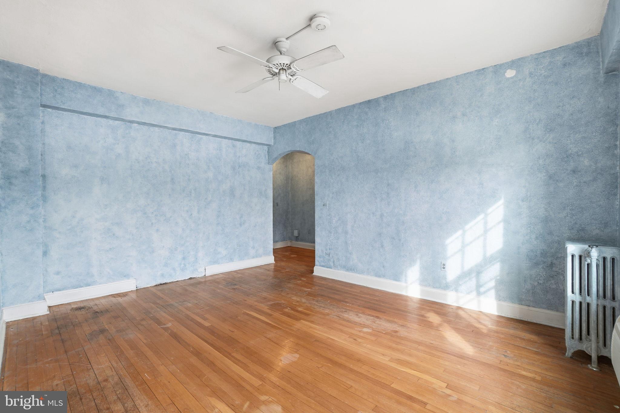 2040 Belmont Road Northwest, Unit 536 Washington, DC 20009 - Photo 4 of 25 Spacious room with serene blue walls.