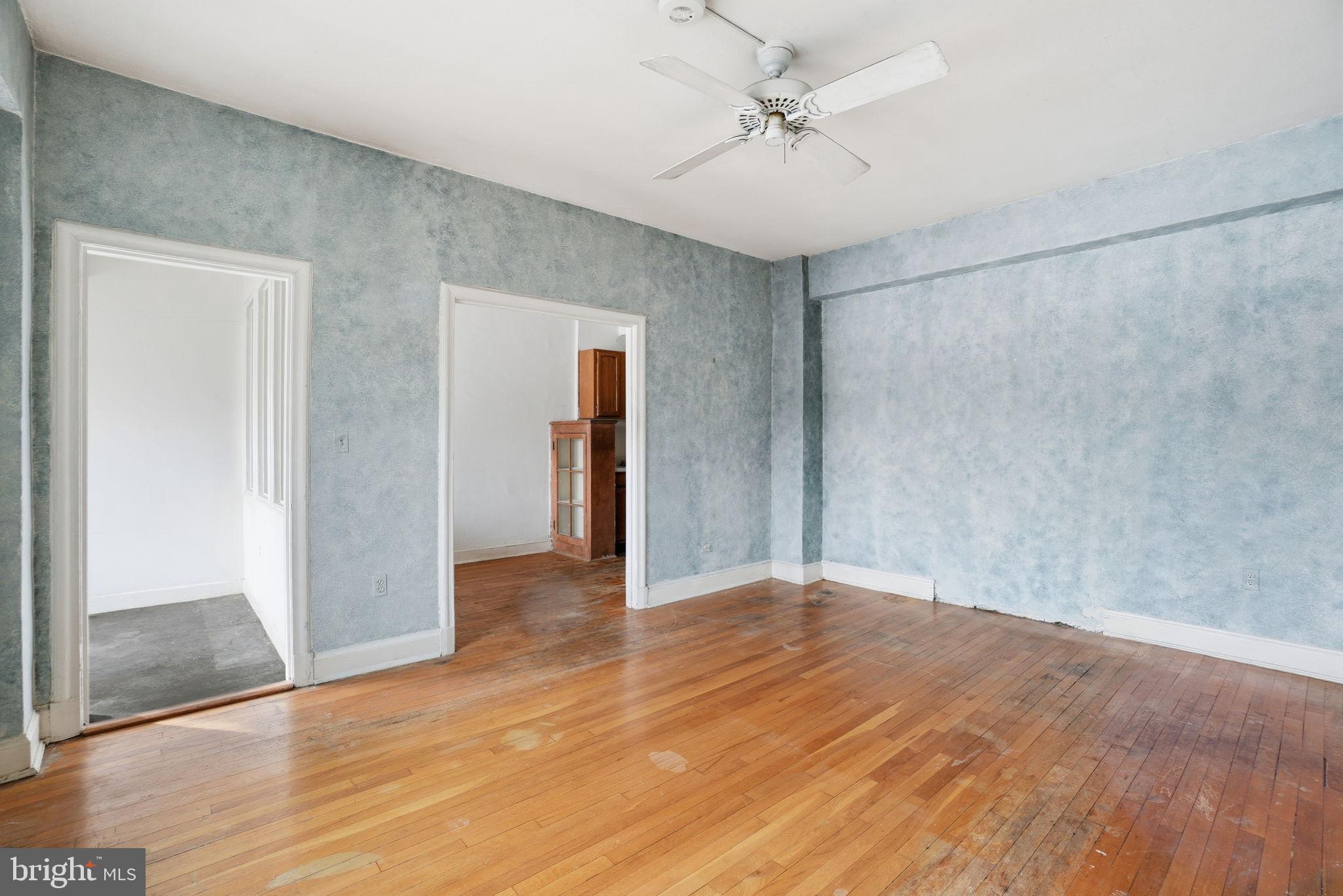 2040 Belmont Road Northwest, Unit 536 Washington, DC 20009 - Photo 5 of 25 Spacious room with textured blue walls.