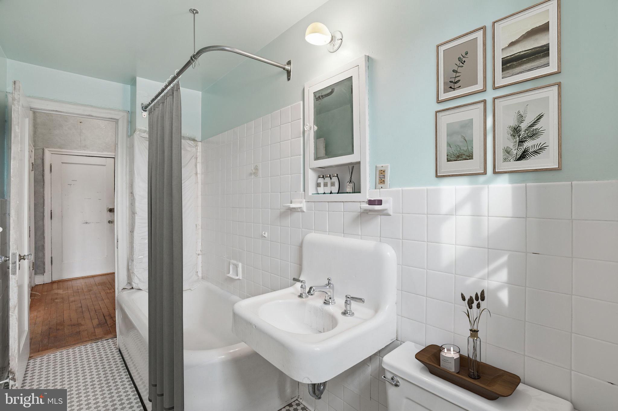 2040 Belmont Road Northwest, Unit 536 Washington, DC 20009 - Photo 5 of 31 a bathroom with a sink a mirror and a shower