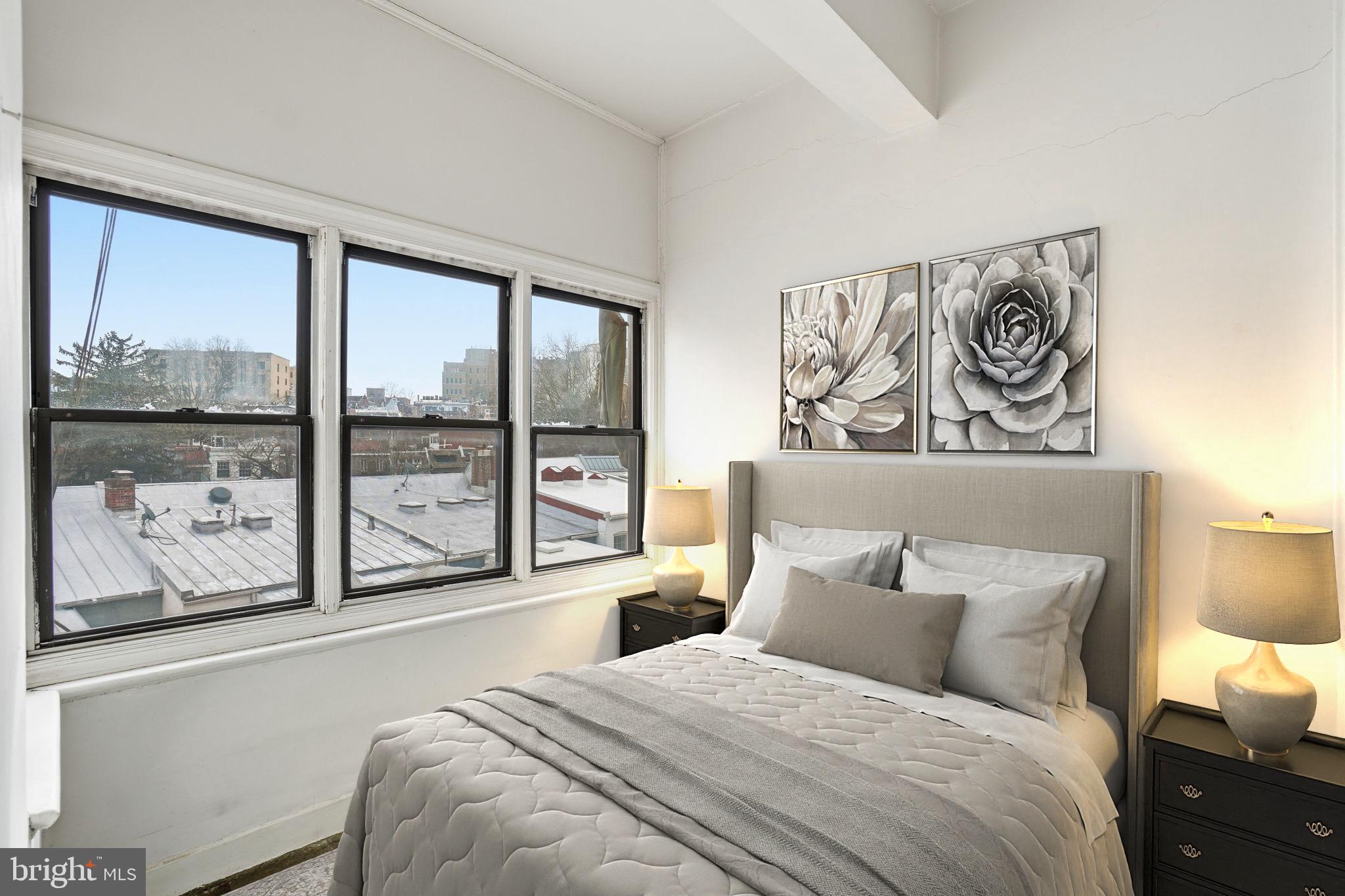 2040 Belmont Road Northwest, Unit 536 Washington, DC 20009 - Photo 6 of 31 a bedroom with a large bed and a window with outer view