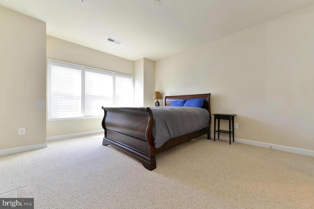 8017 Sport View Road Landover, MD 20785 - Photo 13 of 21 a bedroom with a bed lamp and window