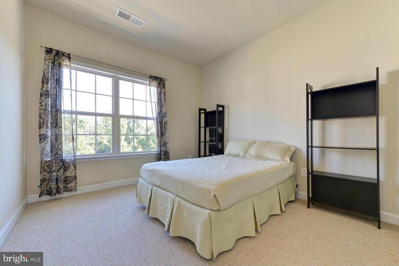8017 Sport View Road Landover, MD 20785 - Photo 16 of 21 a bedroom with a bed and a window