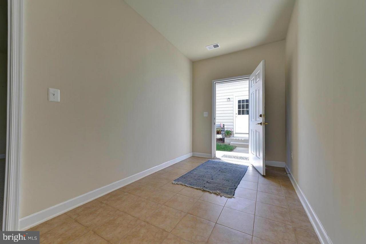 8017 Sport View Road Landover, MD 20785 - Photo 18 of 21 an empty room with an entrance and door