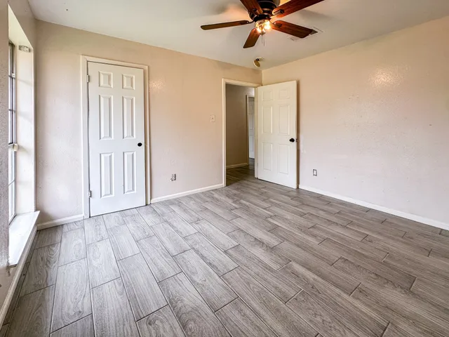 a view of an empty room and wooden floor