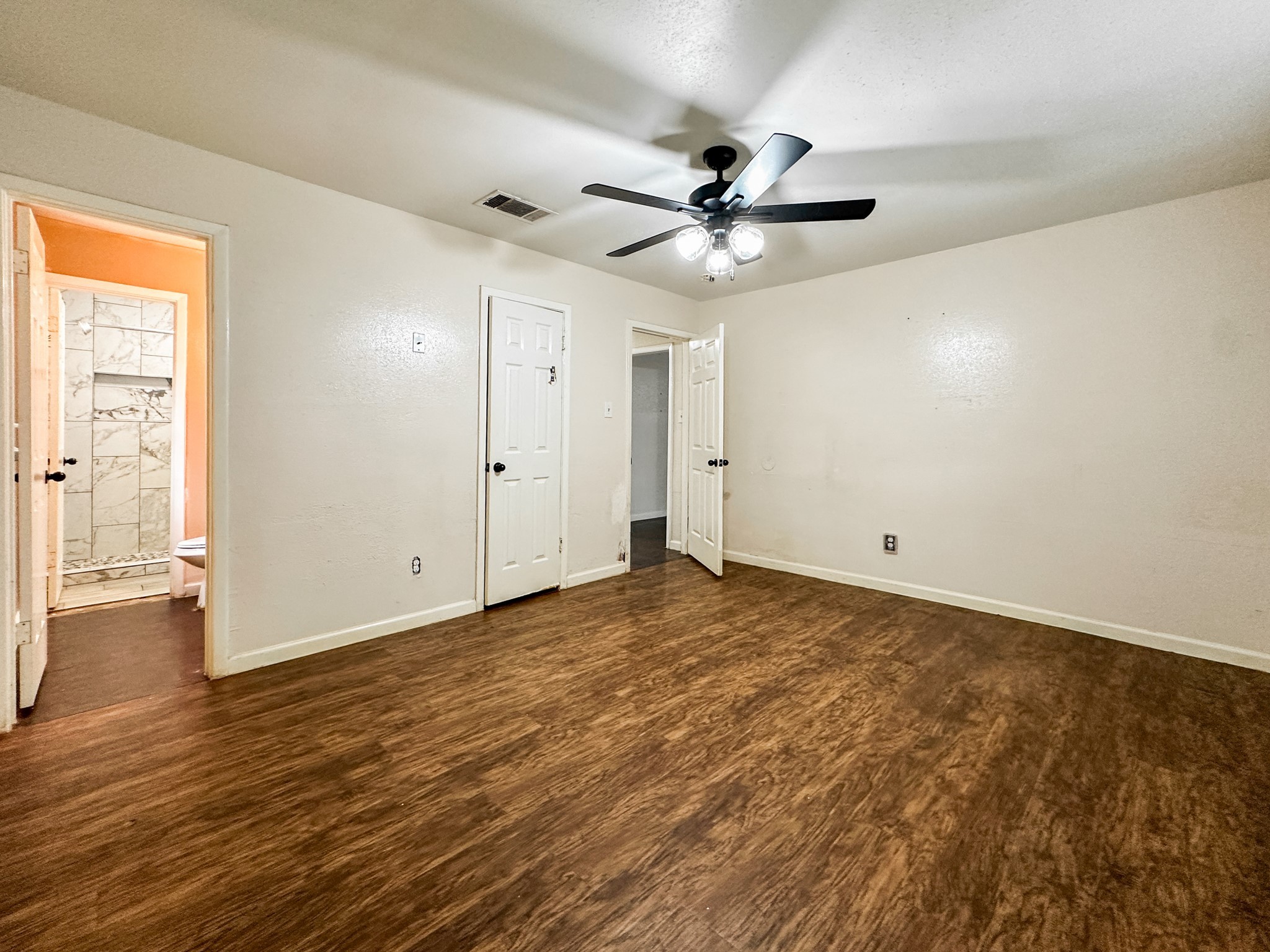 3619 Darling Avenue Pasadena, TX 77503 - Photo 9 of 14 an empty room with wooden floor fan and windows