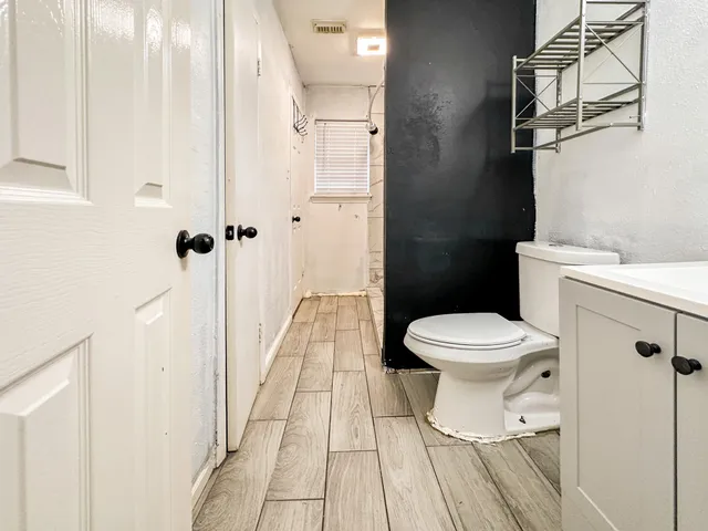 a bathroom with a toilet and a shower
