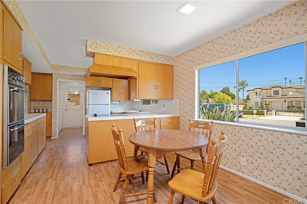 365 Fairview Avenue Arcadia, CA 91007 - Photo 15 of 36 a kitchen with stainless steel appliances kitchen island wooden floors and wooden cabinets