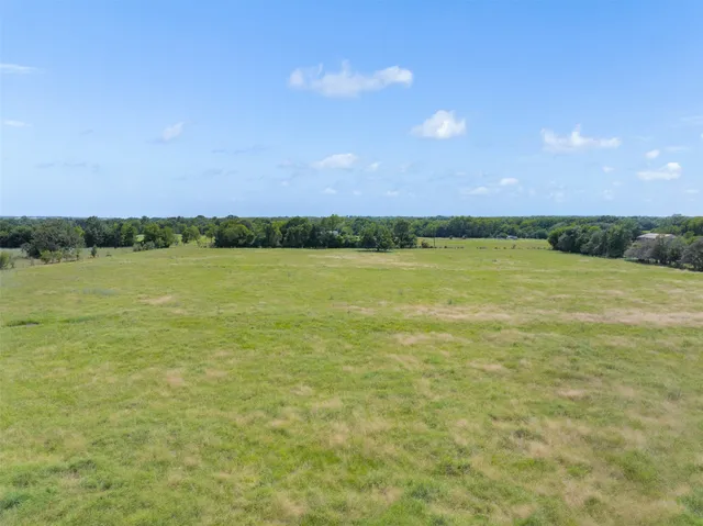 a view of a field with an ocean