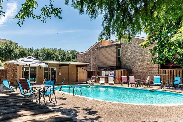 a view of a house with a yard and sitting area