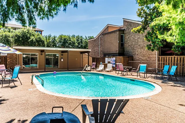 an outdoor space with swimming pool and furniture