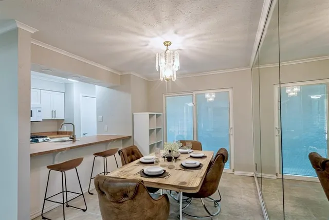 a view of a dining room with furniture and chandelier