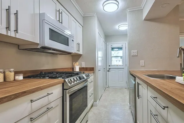 a kitchen with cabinets and stainless steel appliances
