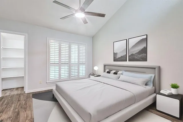 a bedroom with a large bed and a window