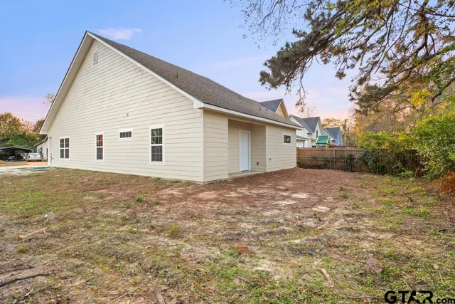 a view of a backyard with a large tree