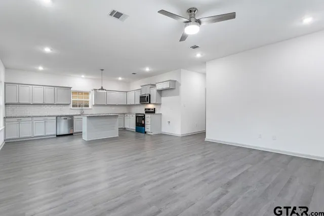 a view of kitchen with wooden floor and window