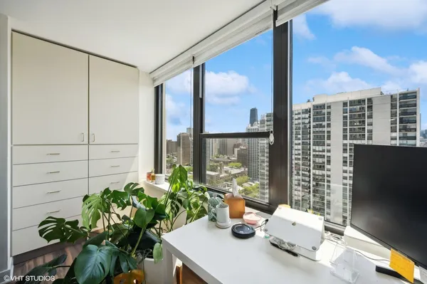 a view of a city from a dining room with furniture