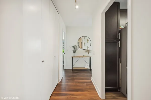 a view of a hallway with wooden floor and entryway
