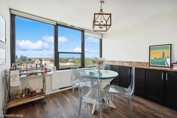 a view of a dining room with furniture large windows and wooden floor
