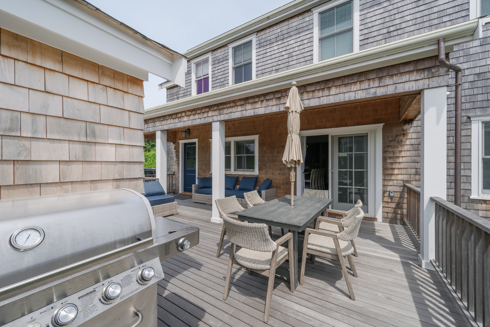 86 Cliff Road Nantucket, MA 02554 - Photo 27 of 29 a view of a dinning table and chairs in patio of the house