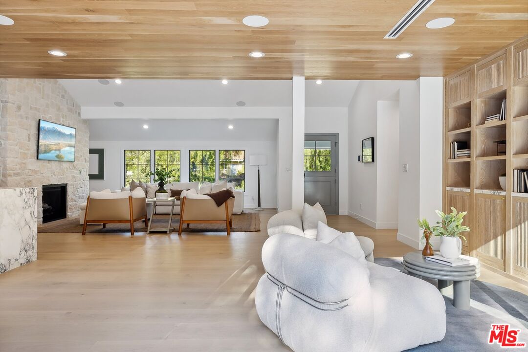 5565 Jed Smith Road Hidden Hills, CA 91302 - Photo 15 of 46 a living room with fireplace furniture and a large window