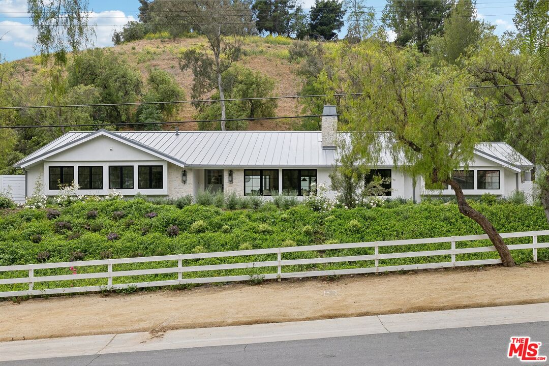 5565 Jed Smith Road Hidden Hills, CA 91302 - Photo 19 of 46 a front view of a house with a yard