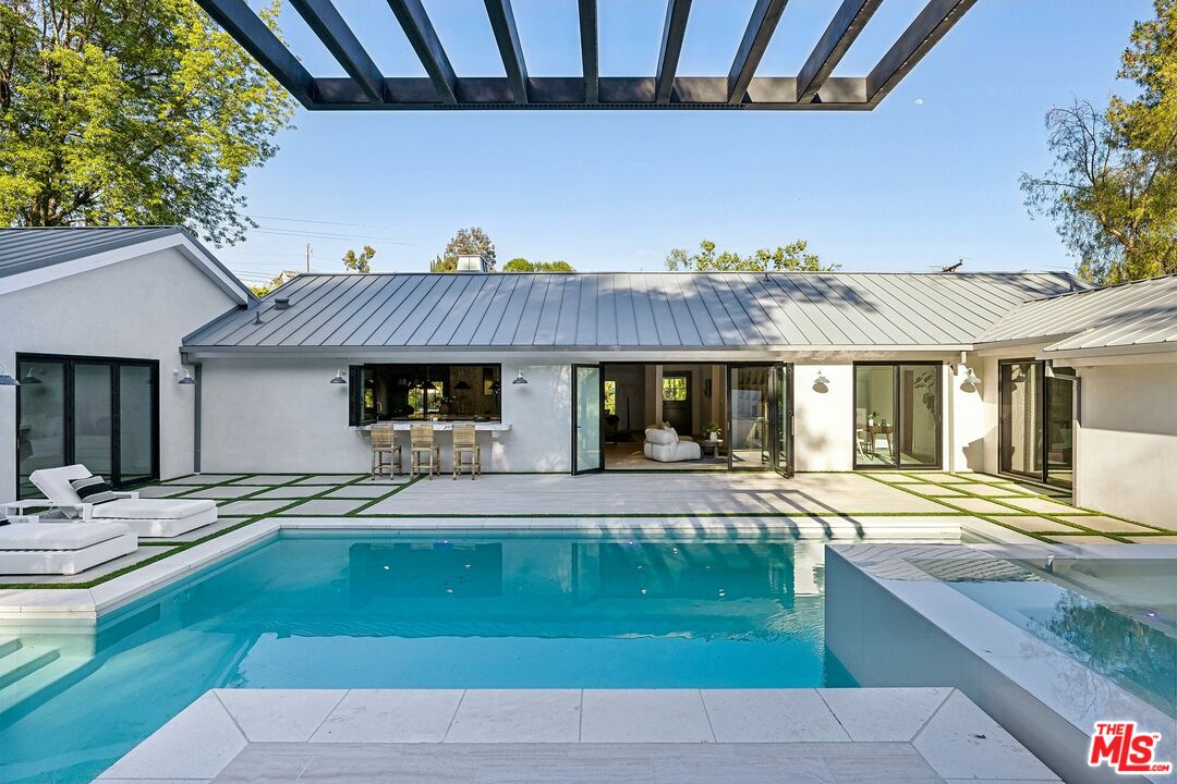 5565 Jed Smith Road Hidden Hills, CA 91302 - Photo 30 of 46 a front view of a house with a garden and yard