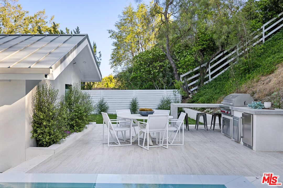 5565 Jed Smith Road Hidden Hills, CA 91302 - Photo 31 of 46 a view of a patio with table and chairs and potted plants