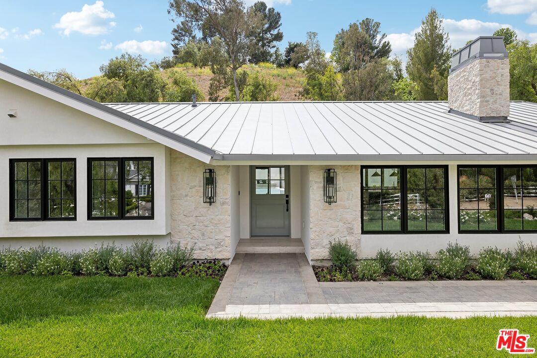 5565 Jed Smith Road Hidden Hills, CA 91302 - Photo 46 of 46 a front view of a house with a yard