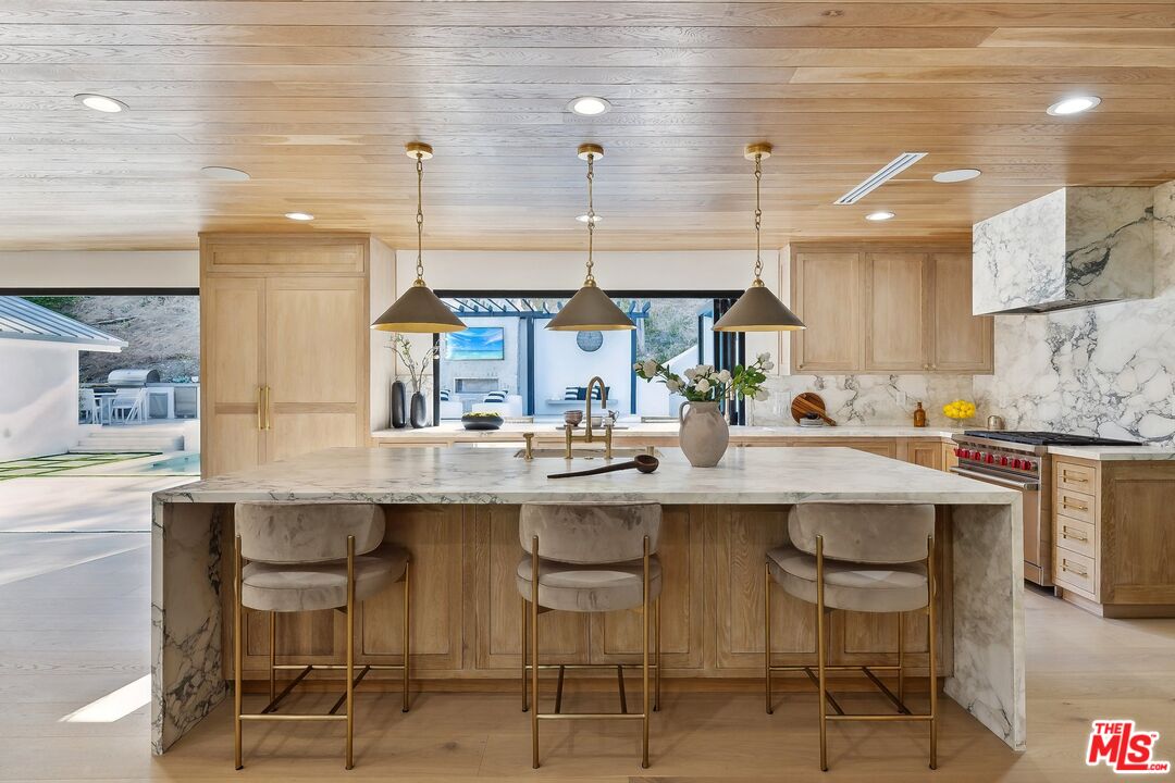 5565 Jed Smith Road Hidden Hills, CA 91302 - Photo 5 of 46 a kitchen with cabinets and chairs