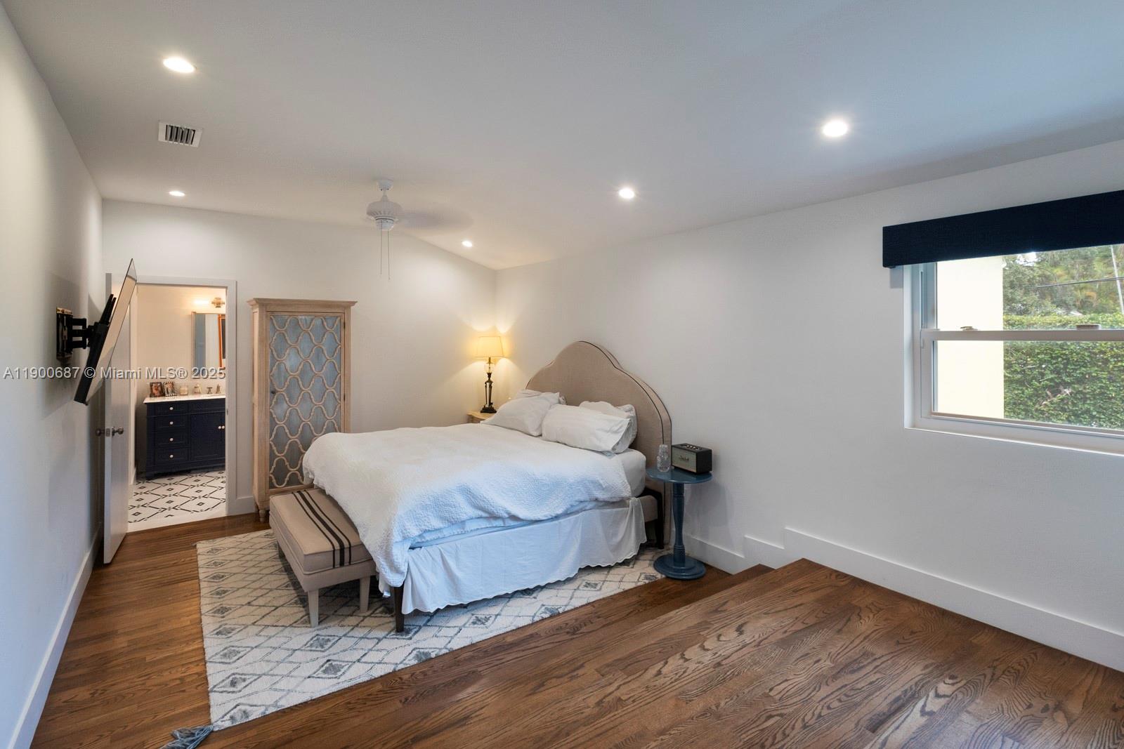 1200 Southwest 18th Street Miami, FL 33145 - Photo 20 of 36 a spacious bedroom with a bed and a fireplace