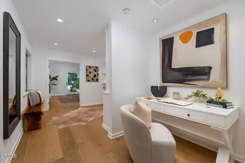 a living room with furniture and a mirror