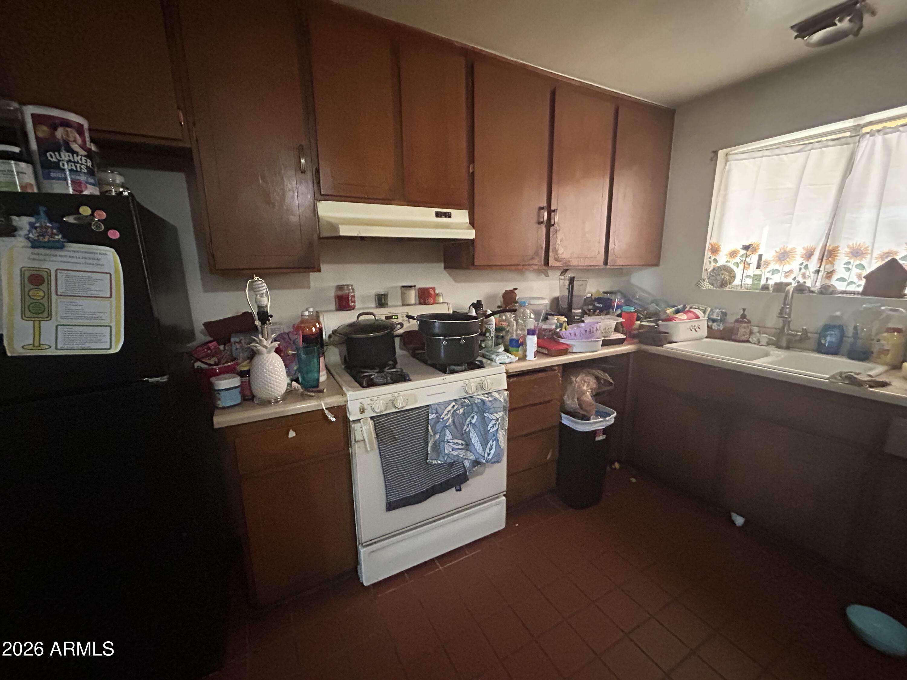12410 North Escobar Way Phoenix, AZ 85022 - Photo 18 of 20 a kitchen with a sink cabinets and window