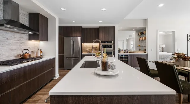 a kitchen with a sink a stove and chairs