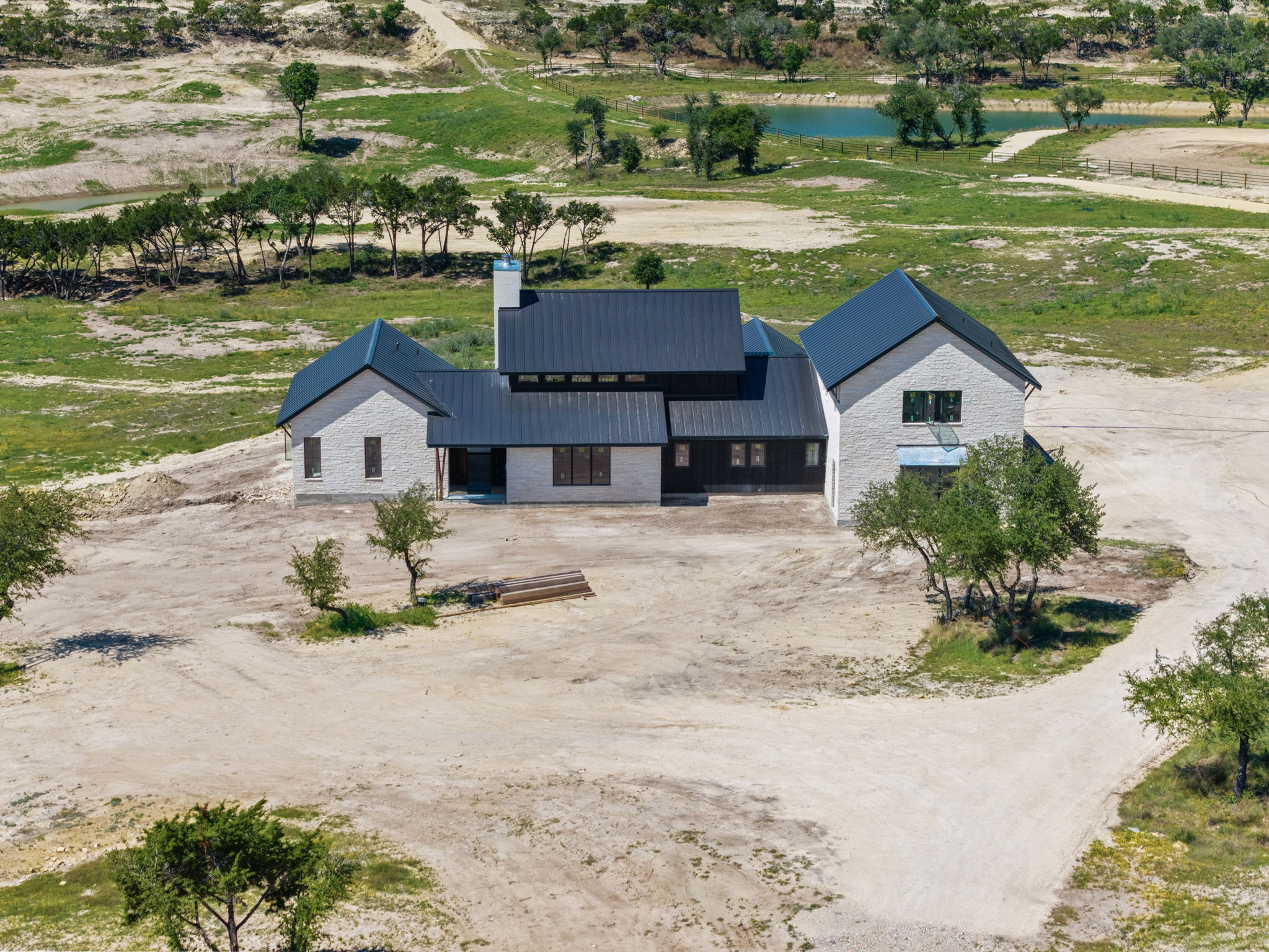a view of a house with a yard and lake view