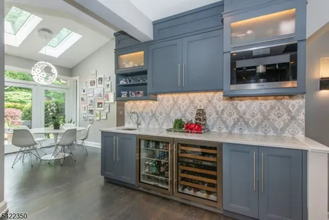 a kitchen with stainless steel appliances granite countertop a stove and cabinets