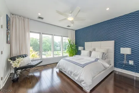 a bedroom with a large bed and a large window