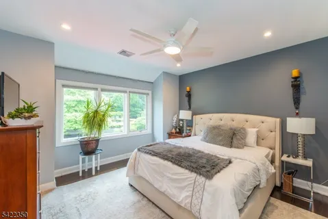 a bedroom with a large bed and a chandelier