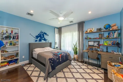 a bedroom with a bed cabinets and book shelf