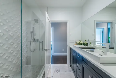 a bathroom with a double vanity sink toilet and shower