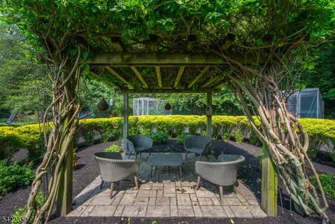 a view of the a patio with couches and table and chairs under an umbrella